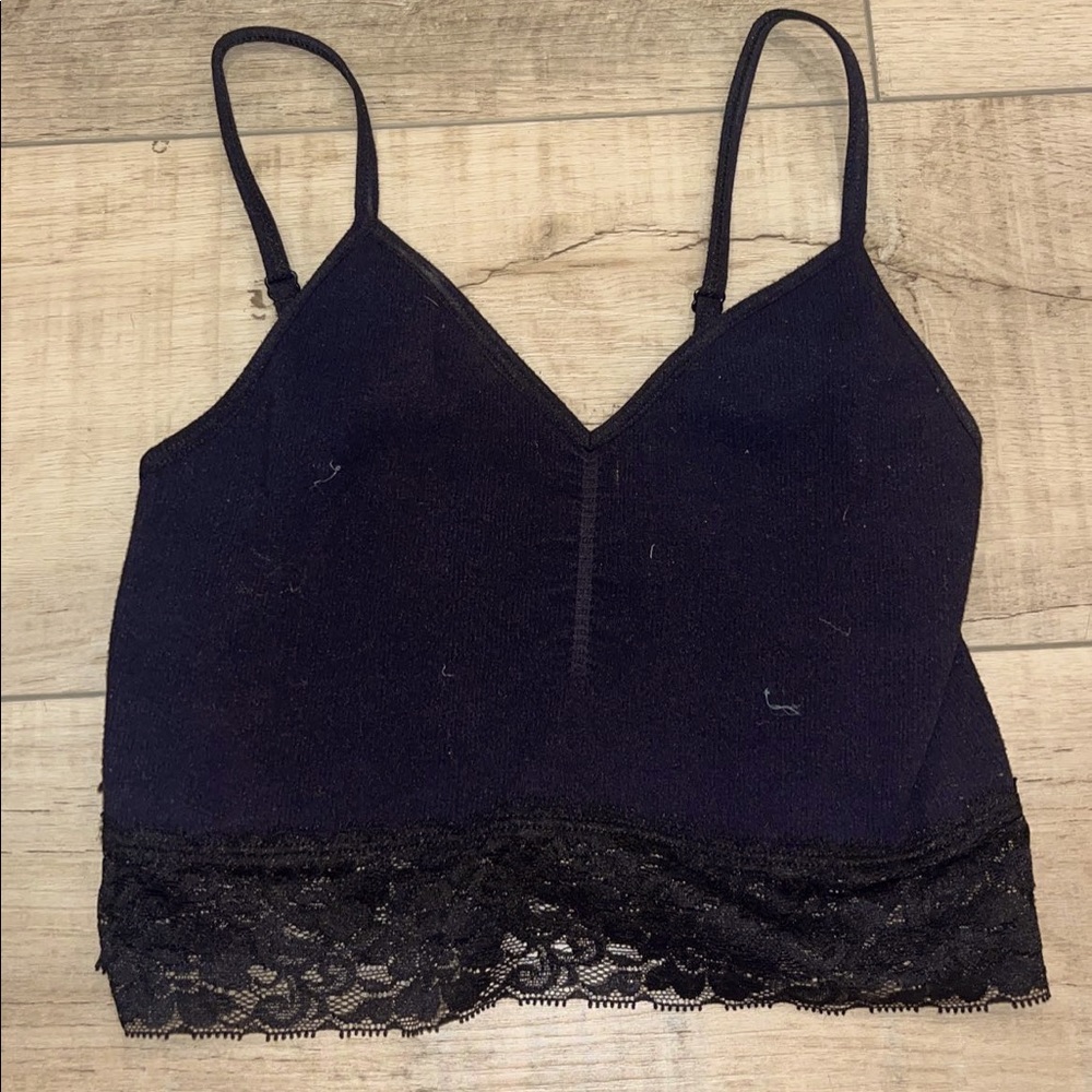 black tank top with lace on the bottom. adjustable straps and tight fit.